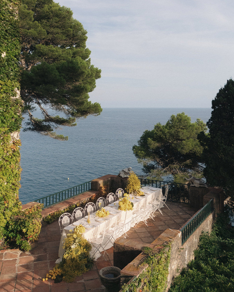 Dinner tables on the sea terrace of Casa Santa Clotilde over the Mediterranean